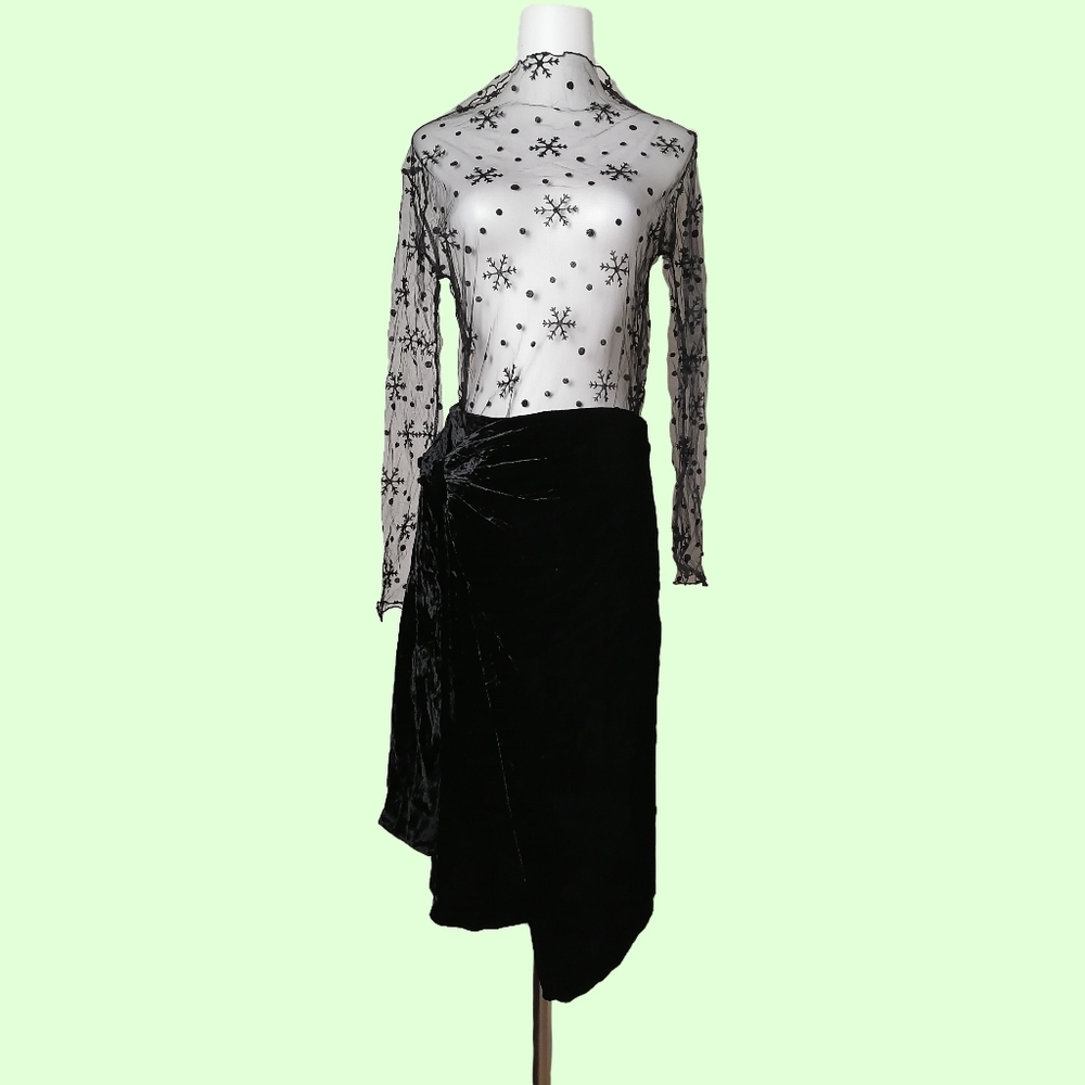 black velvet skirt and black fishnet long-sleeve top